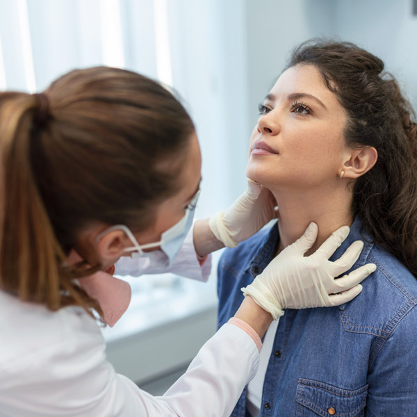 woman getting thyroid checked